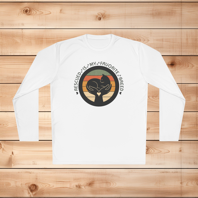 White Sport-Tek long sleeve shirt with text saying "Rescued Is My Favorite Breed," with a black and white graphic on a wooden background