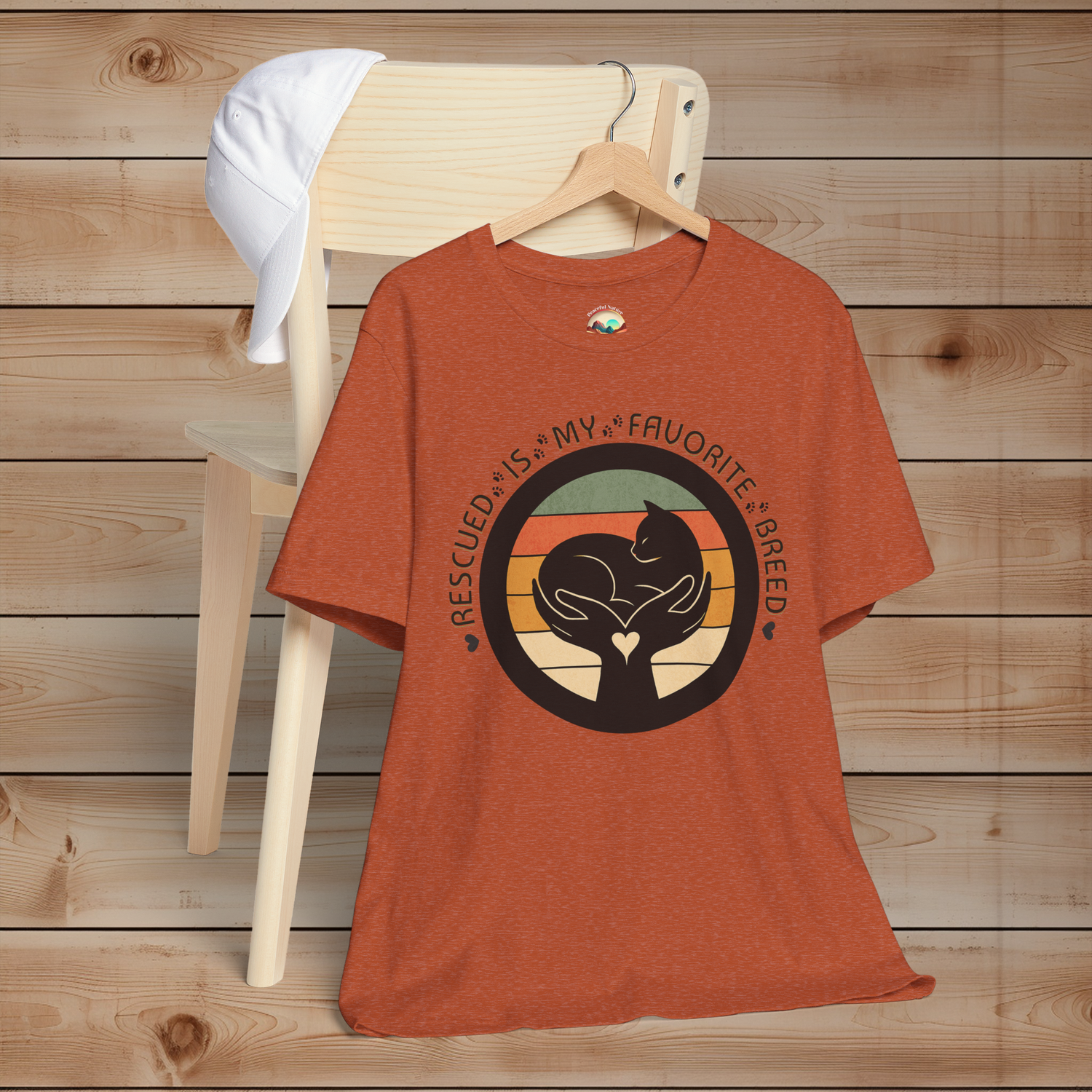 Heather Autumn cat rescue T-shirt – ‘Rescued Is My Favorite Breed’ graphic with vintage sunset circle and minimalist cat silhouette.