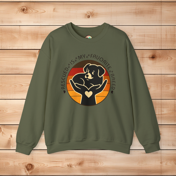 Military green Gildan 18000 sweatshirt with Rescued Is My Favorite Breed graphic featuring a dog in hands symbolizing compassion and adoption