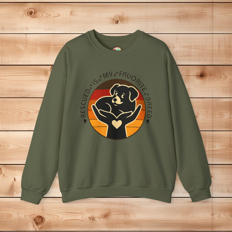 Military green Gildan 18000 sweatshirt with Rescued Is My Favorite Breed graphic featuring a dog in hands symbolizing compassion and adoption