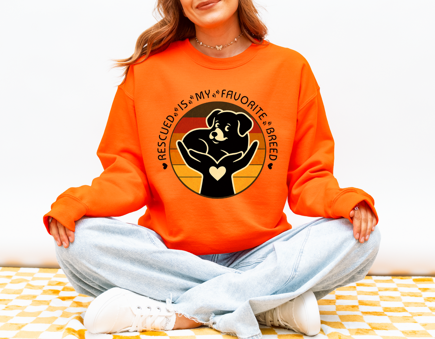 Woman wearing safety orange Rescued Is My Favorite Breed Gildan 18000 sweatshirt supporting animal rescue and adopt-don’t-shop awareness