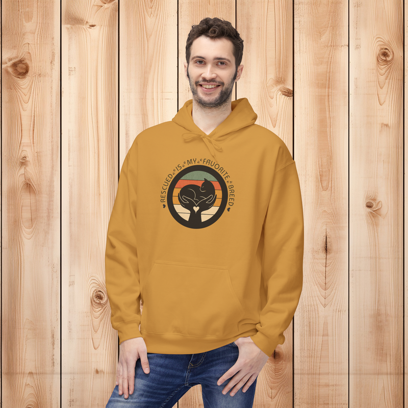 Male model wearing a mustard-colored 'Rescued Is My Favorite Breed' retro cat rescue hoodie in front of a wooden panel background.