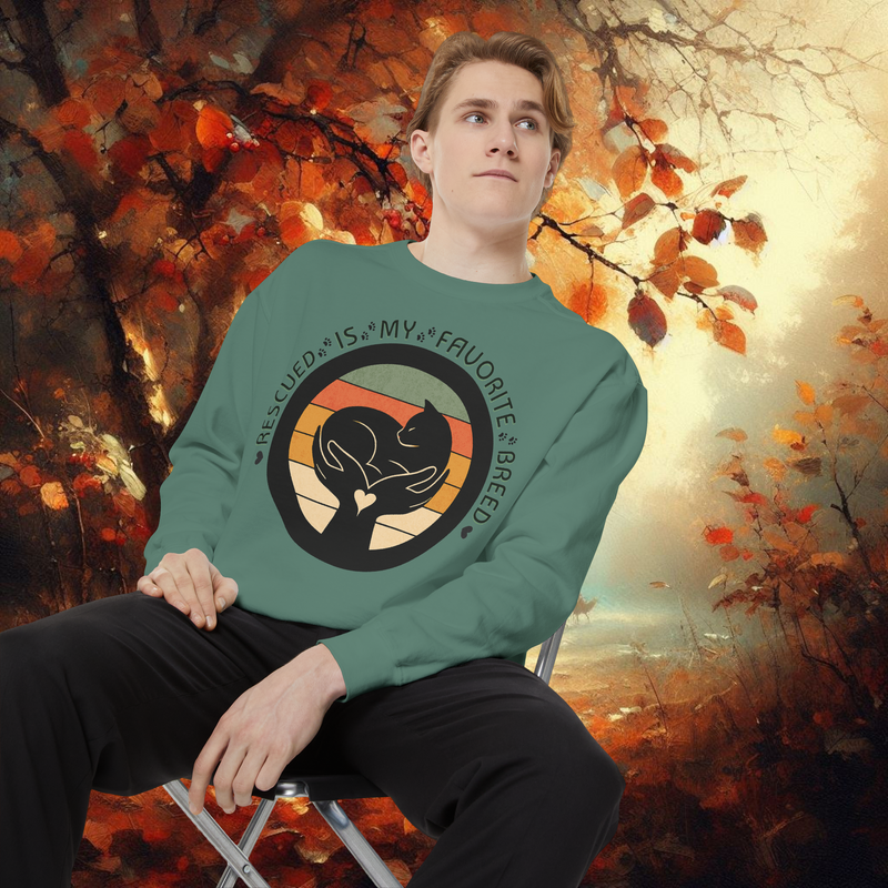 Model in light green Comfort Colors 1566 garment-dyed sweatshirt with animal rescue message ‘Rescued Is My Favorite Breed,’ photographed in cozy fall scene