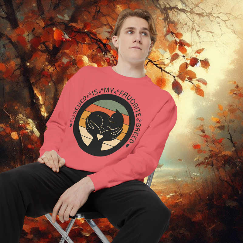 Model wearing watermelon pink Comfort Colors 1566 sweatshirt with ‘Rescued Is My Favorite Breed’ design for pet lovers, autumn forest background