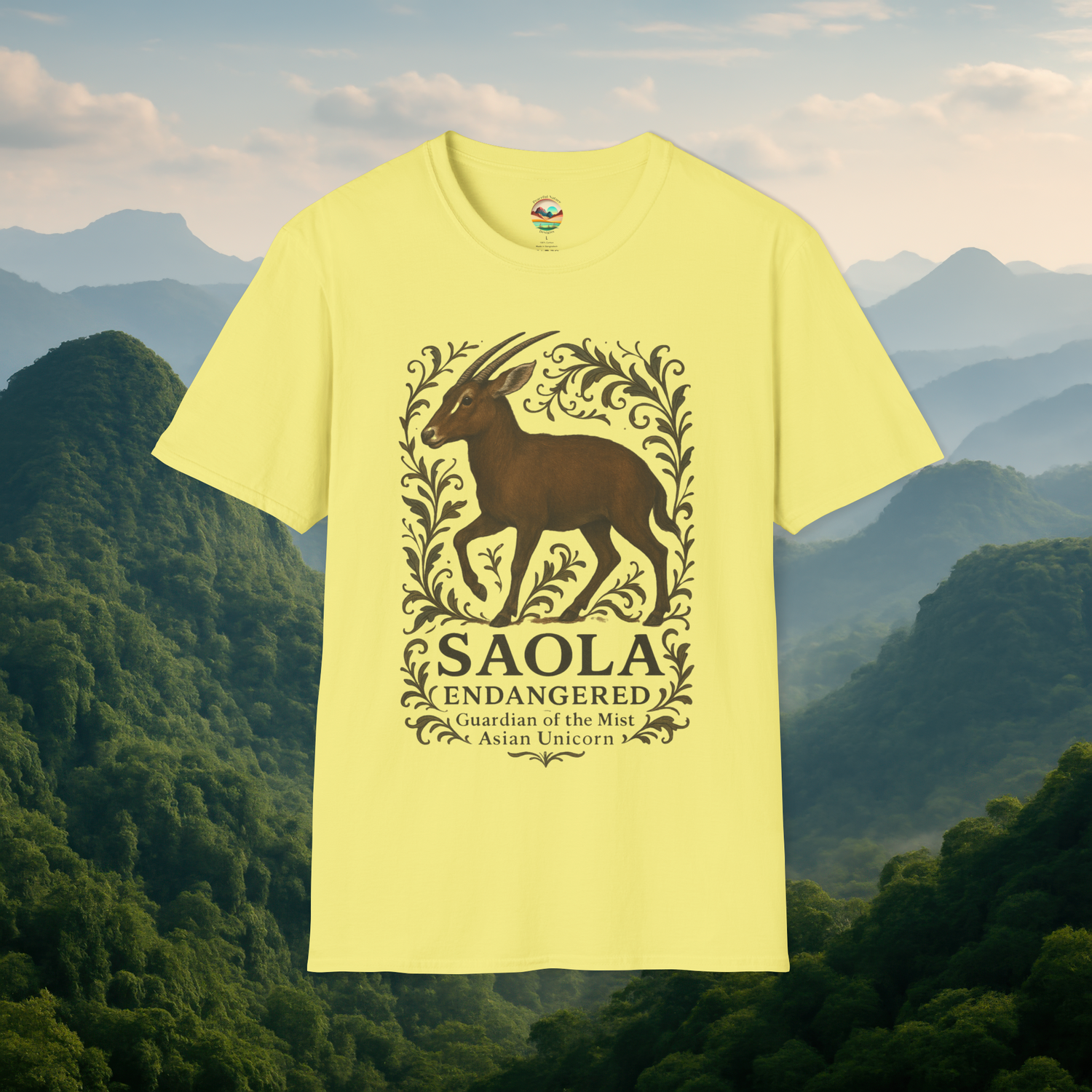 Saola Endangered Asian Unicorn T-Shirt in Cornsilk Yellow – Features a detailed Saola illustration framed by botanical elements. Lightweight soft-style tee, displayed against a misty mountain background