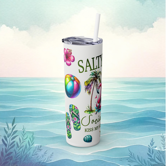 Left side of the white Salty Bitch tumbler design showing floral flip flops, rainbow beach ball, hibiscus, and tropical palm accents