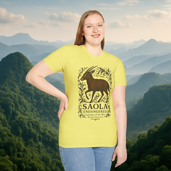 Woman modeling the Saola Endangered Asian Unicorn T-Shirt in Cornsilk Yellow – soft-style eco-conscious cotton tee with a Saola illustration, captured against a misty mountain backdrop