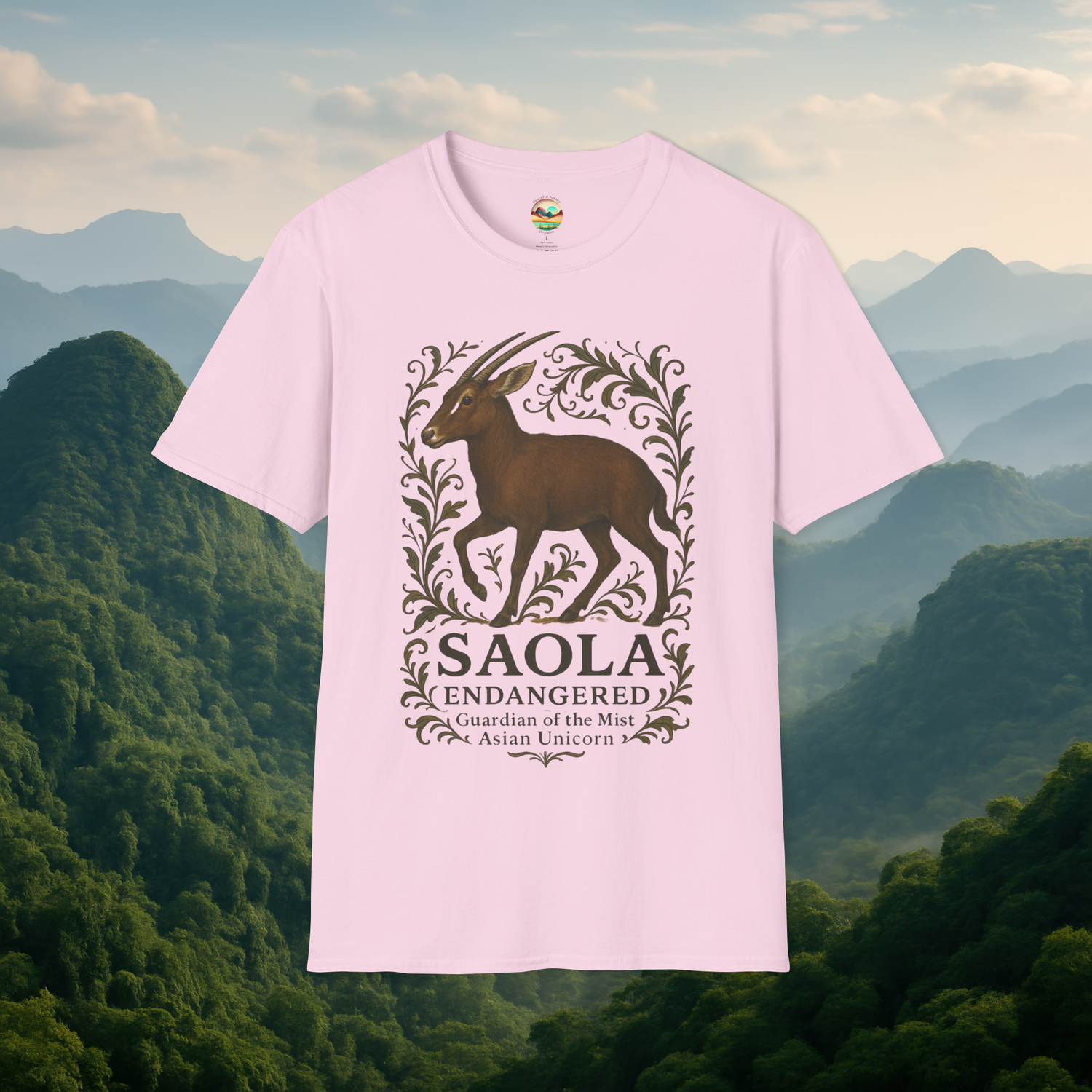 Saola Endangered Asian Unicorn T-Shirt in Light Pink – Beautifully detailed Saola and botanical design printed on a premium soft-style cotton tee, with a serene mountain landscape backdrop