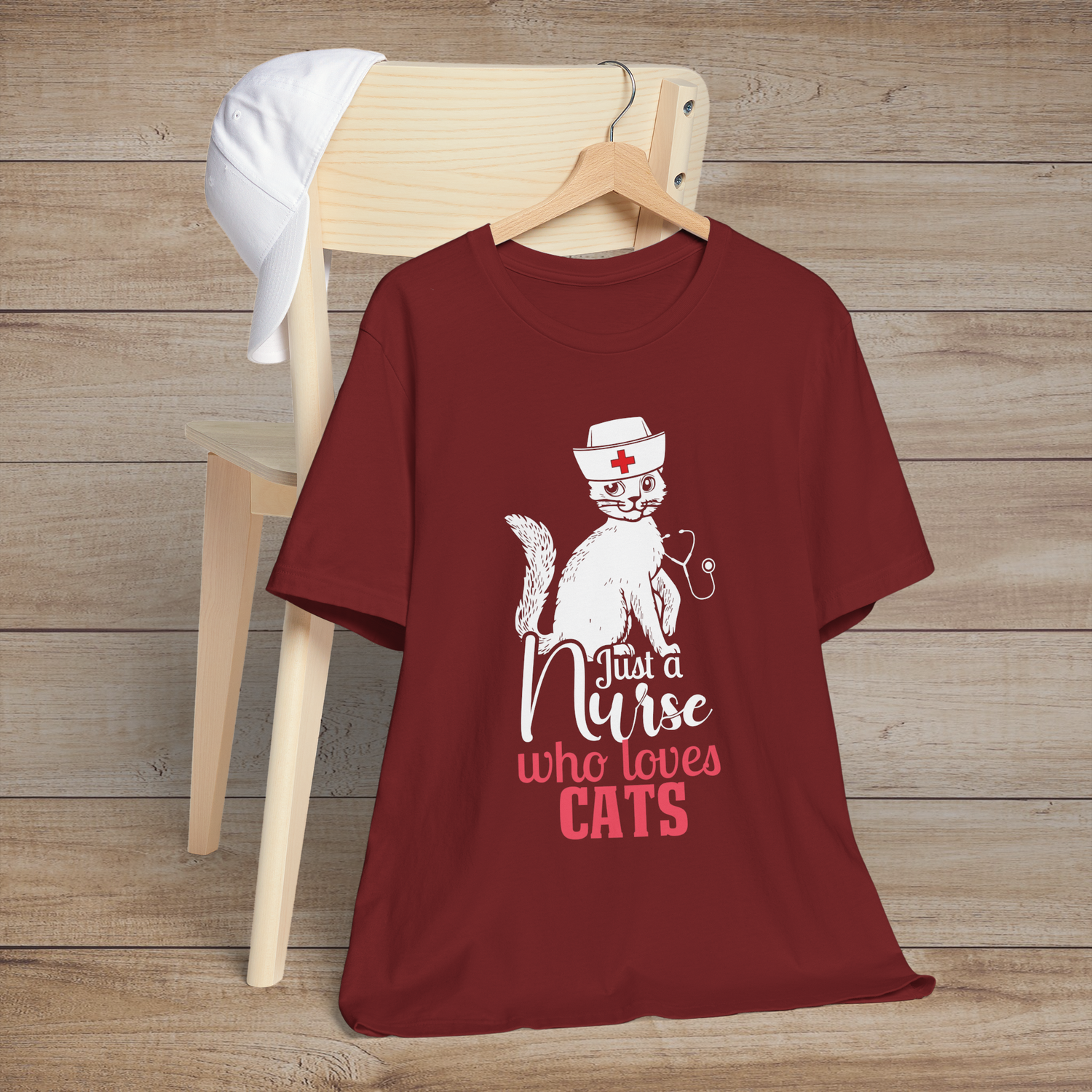 Cardinal red t-shirt with a cute white cat in a nurse’s hat sitting above the text Just a Nurse Who Loves Cats