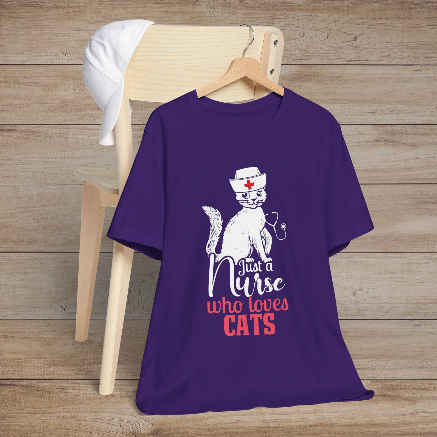 Purple t-shirt with a playful cat in a nurse’s hat sitting atop the words Just a Nurse Who Loves Cats
