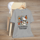 Heather gray t-shirt featuring a skull with a skeleton hand holding colorful flowers and butterflies with the text Sensitive Savage