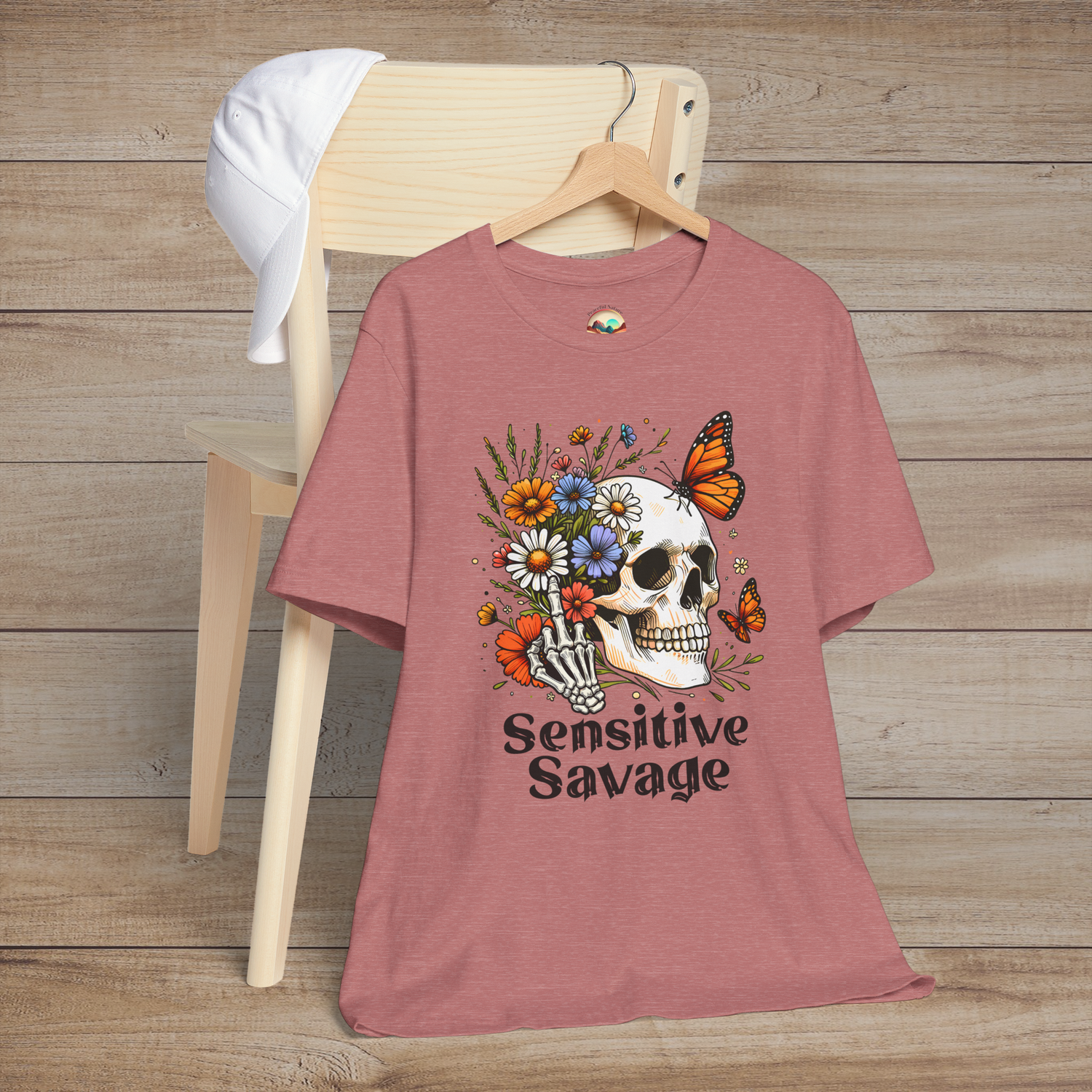Heather mauve t-shirt with colorful gothic artwork of a skull, flowers, butterflies, and the phrase Sensitive Savage