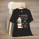 Funny cat adoption quote tee in black – stacked cartoon cats with “So apparently I'm not allowed to adopt all the cats… Rude, but OK” text.