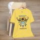 Somebody’s Problem T-Shirt featuring a Boho buffalo skull with feathers and sunflowers on maize yellow fabric