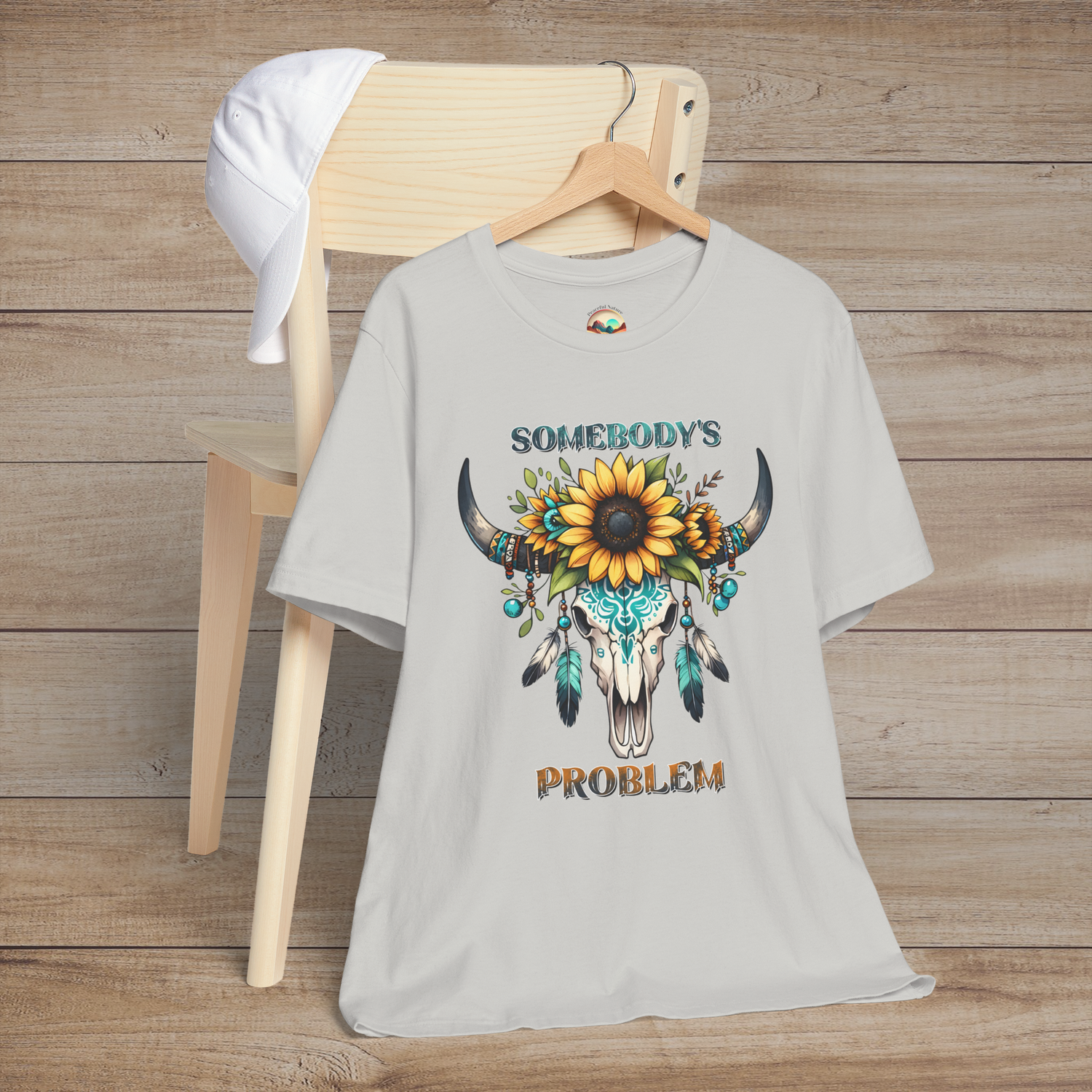 Somebody’s Problem T-Shirt featuring a Boho western skull with sunflowers and turquoise accents on silver fabric
