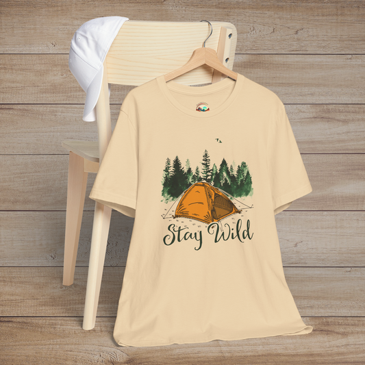 Soft cream Stay Wild Camper T-Shirt with a vibrant orange tent, forest background, and the words "Stay Wild"