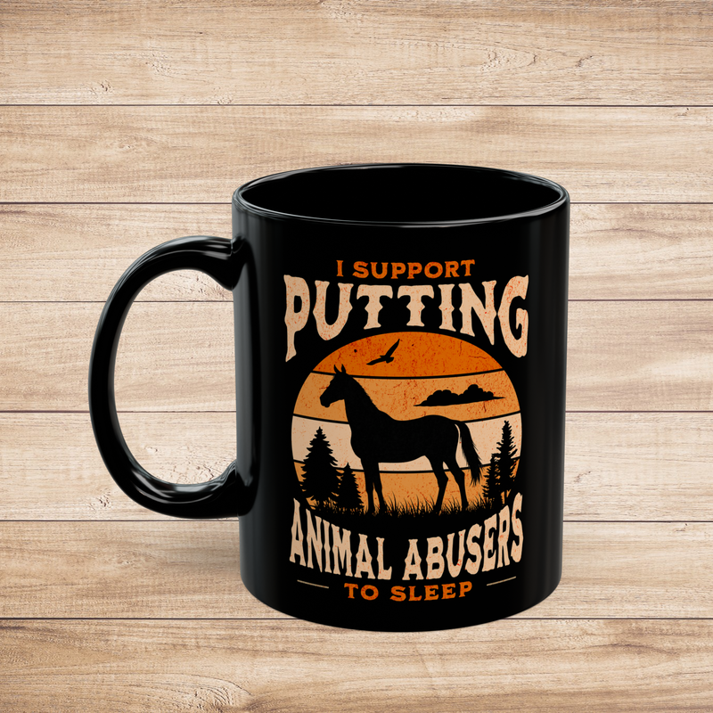 Black 11oz ceramic mug (left view) with horse silhouette and rustic sunset design, reading “I Support Putting Animal Abusers to Sleep,” on wood background.
