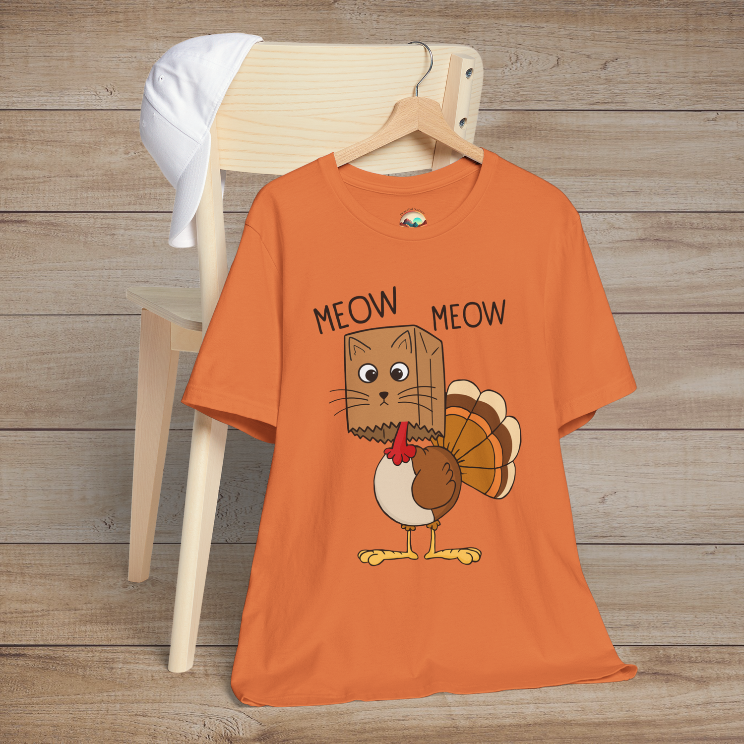 Cartoon cat in turkey costume with “Meow Meow” text on burnt orange unisex tee, perfect for Thanksgiving