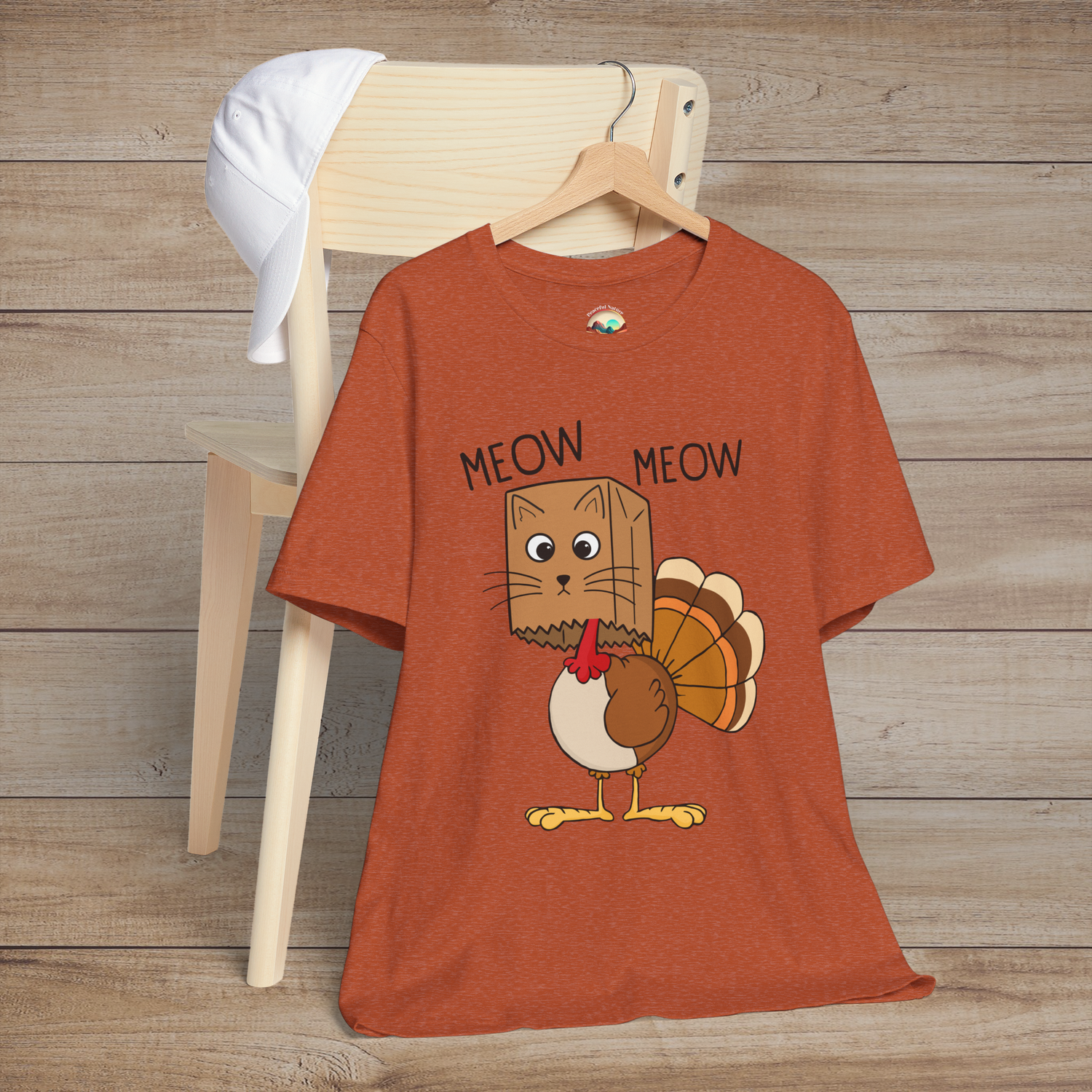 Funny Thanksgiving cat-turkey mashup tee in heather autumn, with quirky “Meow Meow” phrase