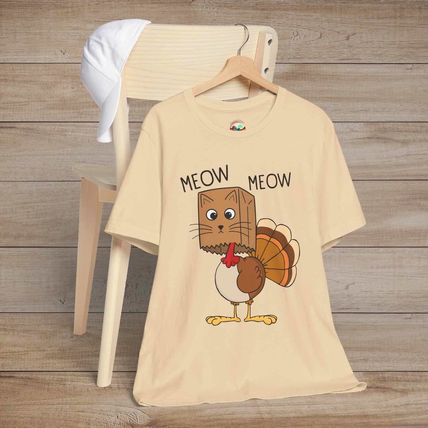  Light cream t-shirt with adorable cartoon cat disguised as a turkey, says “Meow Meow”