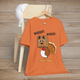 Funny Thanksgiving shirt with a turkey wearing a dog mask saying “Woof! Woof!” on burnt orange tee