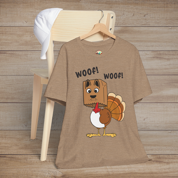 Cartoon turkey pretending to be a dog with “Woof! Woof!” text on heather tan holiday tee