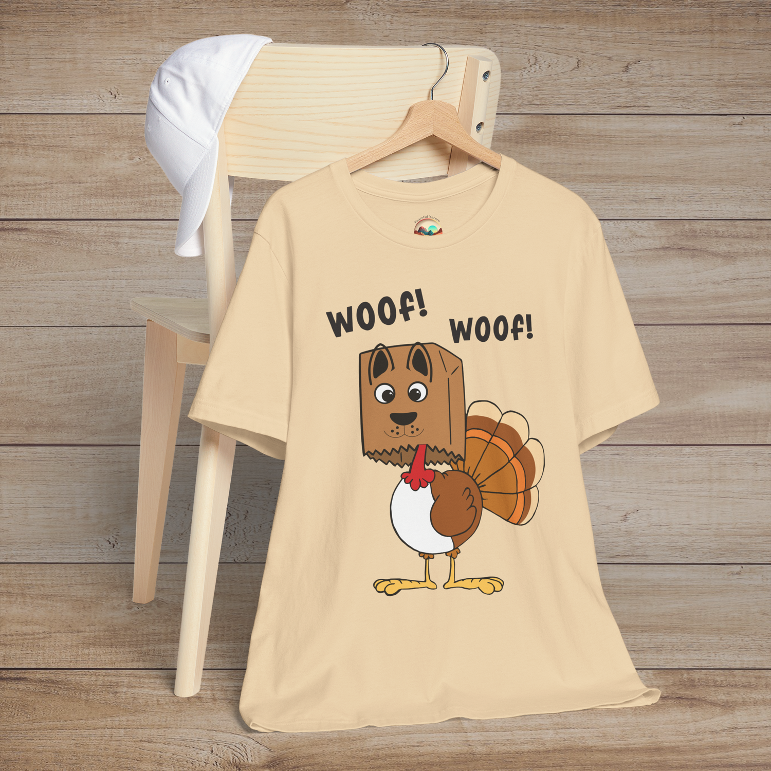 Turkey wearing dog disguise on soft cream t-shirt, funny Thanksgiving design with “Woof! Woof!”