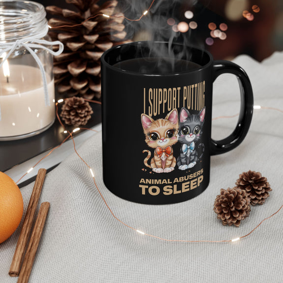 Black 11oz mug with strong animal advocacy message, shown in a sleek workspace setting.