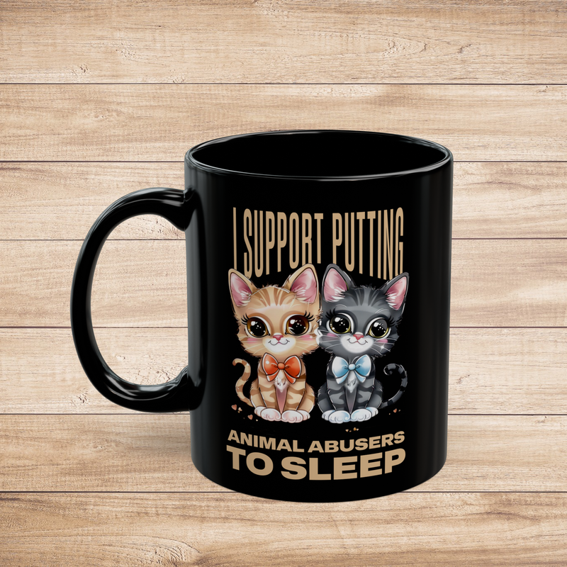 Close-up of the left side of a black 11oz mug with two adorable cartoon cats and bold animal rights text.