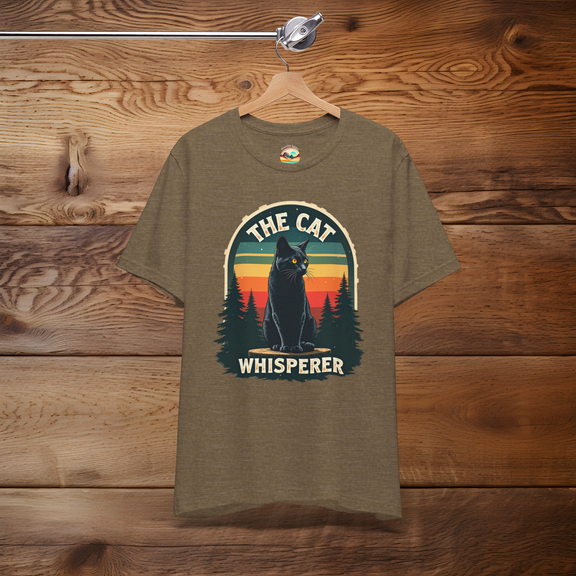 The Cat Whisperer T-Shirt with a mystical black cat and retro sunset, displayed on a heather olive background for cat lovers and nature fans