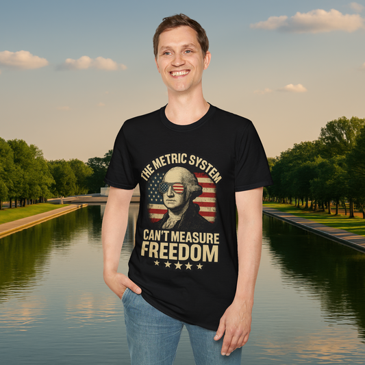 Smiling male model wearing a black 'The Metric System Can’t Measure Freedom' T-shirt with a distressed George Washington graphic and patriotic theme