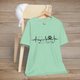Heather mint t-shirt with clean vet tech-themed design of a heartbeat line, stethoscope, paw print, and hashtag #VetTech